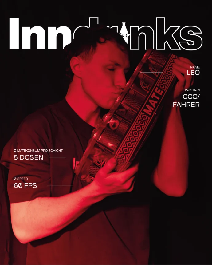 Eine Person steht vor schwarzem Hintergrund in rotem Licht und hält ein großes Paket Mate-Dosen, das sie mit geschlossenen Augen an die Lippen führt. Auf dem Bild sind typografische Elemente im Magazin-Stil platziert, darunter Angaben wie durchschnittlicher Matekonsum pro Schicht und Geschwindigkeit.